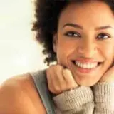 Woman smiling with healthy gums using GumAktiv